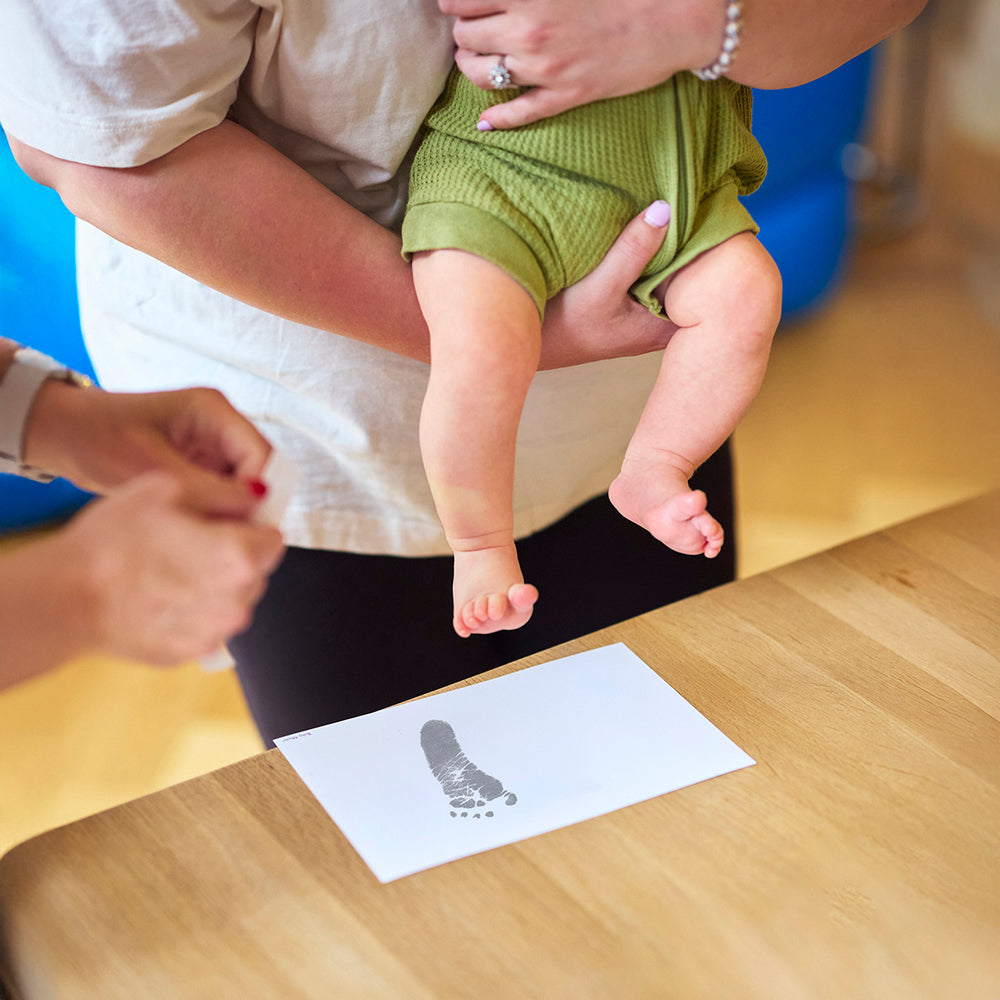 Baby Made inkless print kit and hands and feet casting kit on a white background